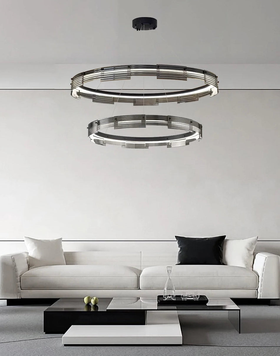 Modern living room with a white sofa and stylish ceiling lights.