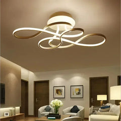 Living room interior with a gold swirl flush mount ceiling light providing ambient illumination.