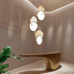 Gold geometric pendant lights in a modern reception area.