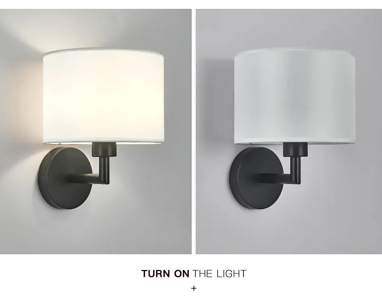 Two wall sconces with white shades and black metal bases on a gray background.