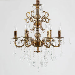Front view of a coppery multi-arm chandelier adorned with crystal accents and faux candle bulbs.