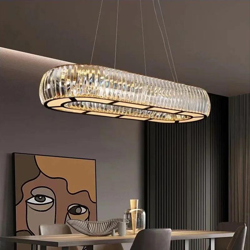 Rectangular variant of a crystal pendant light with chrome finish, hanging over a dining table.