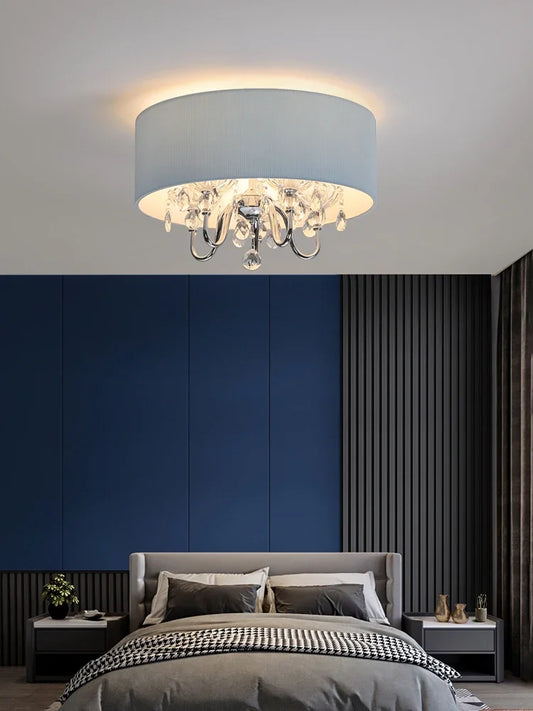Close-up view of the blue fabric drum pendant light's crystal details and chrome hardware.