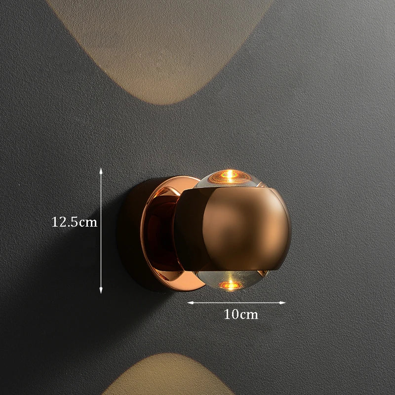 Bronze wall light fixture on a dark gray wall with measurements indicated.
