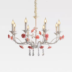 White floral crystal candelabra chandelier with pink roses and teardrop crystals, isolated on a white background.