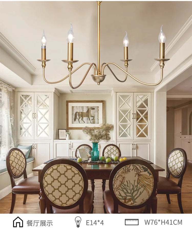 Gold candelabra-style chandelier installed above a dining table in a well-lit room.