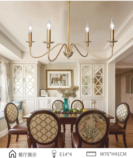 Gold candelabra-style chandelier installed above a dining table in a well-lit room.