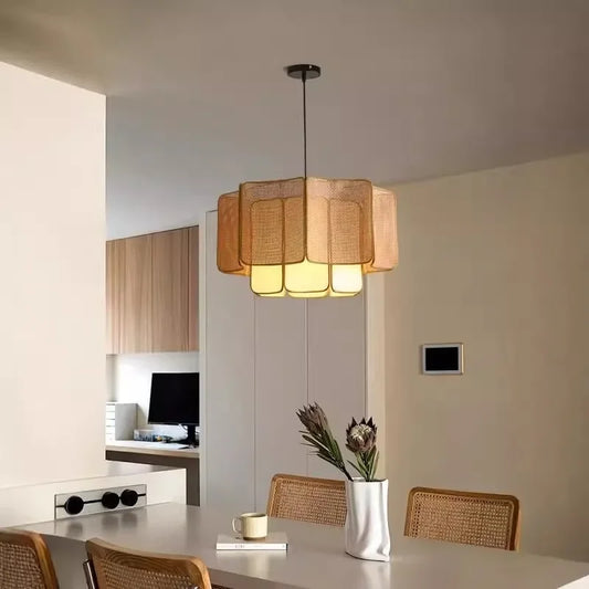 A natural-toned rattan woven tiered pendant light illuminating a dining area with a modern Bohemian aesthetic.