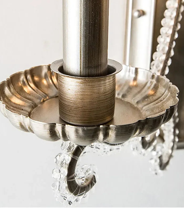 Close-up of a decorative metal fixture with crystal elements on a white background