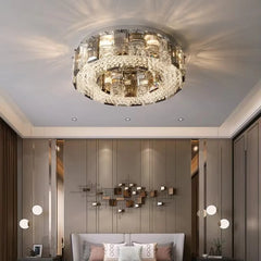A luxurious living room featuring a large, round semi-flush ceiling light with crystal accents, casting a warm glow.