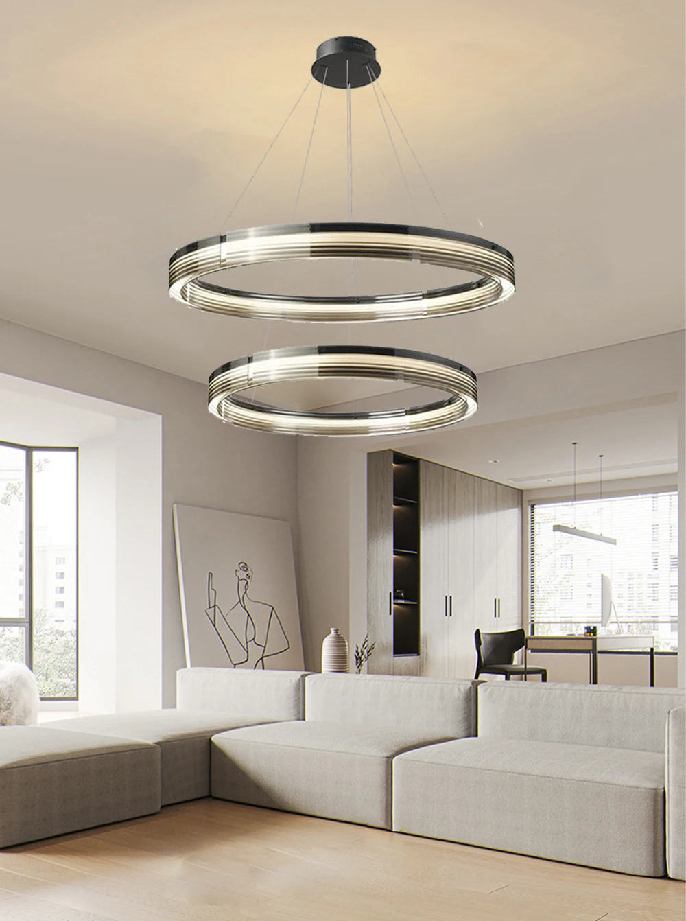 Modern chandelier hanging in a living room with a neutral color scheme