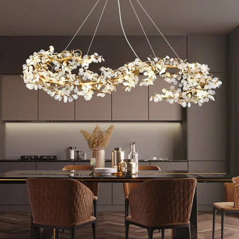 Modern chandelier hanging above a kitchen table with chairs.