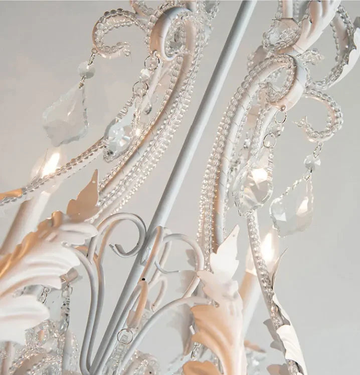 Close-up of an ornate chandelier with intricate designs and crystal accents.