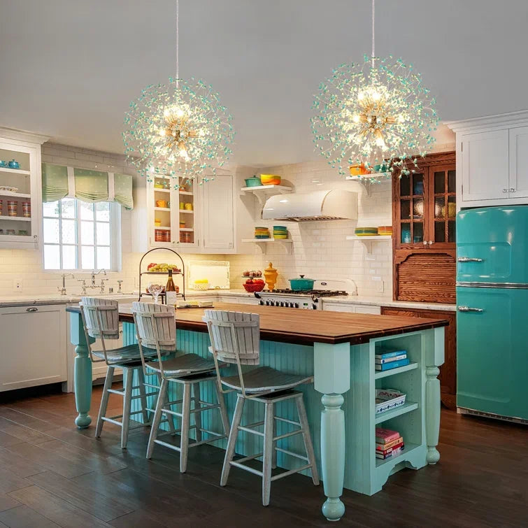 Modern kitchen with turquoise island, bar stools, and decorative pendant lights.