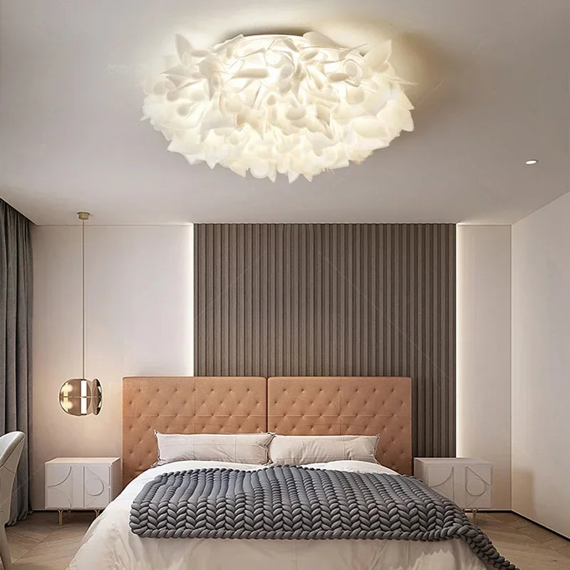 View of a white petal flush mount ceiling light illuminating a room.