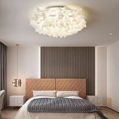 View of a white petal flush mount ceiling light illuminating a room.