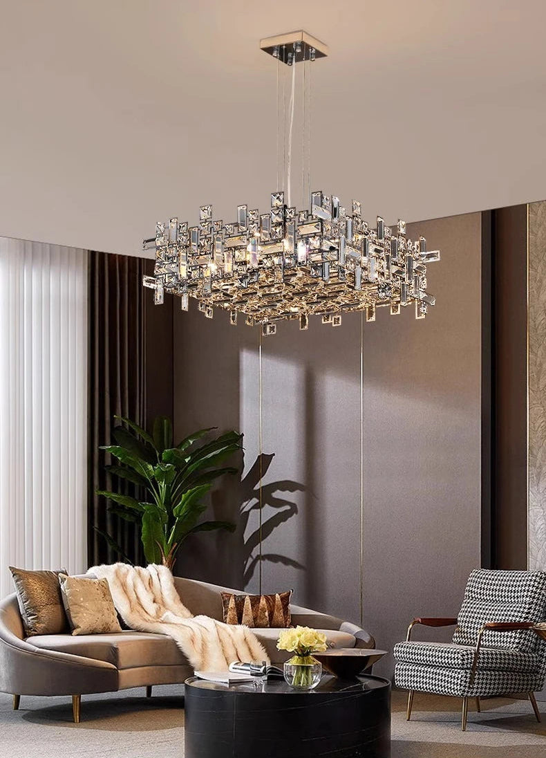 Chandelier hanging in a living room with a sofa and chair.