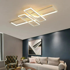 Black geometric semi-flush ceiling light installed in a modern living room.