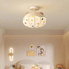 White ceiling light shaped like a hot air balloon with colorful polka dots and wooden bear ears, mounted on a white ceiling.