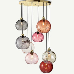 A multi-color textured glass globe pendant light arrangement in a room setting