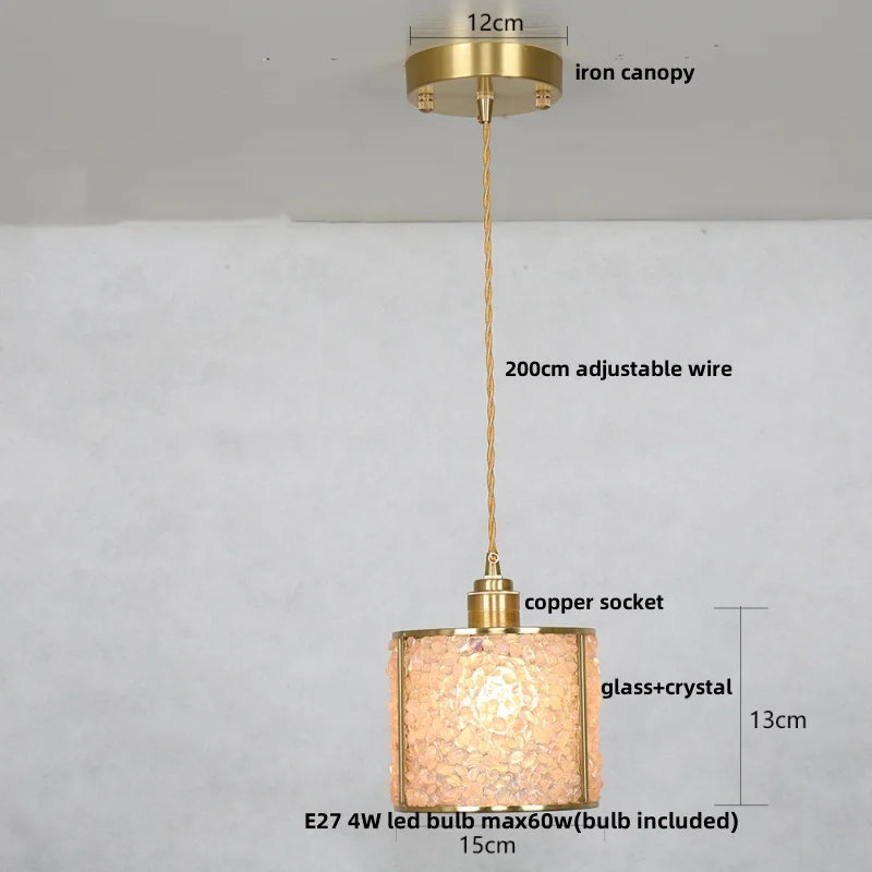 Gold pendant light with measurements on a gray background