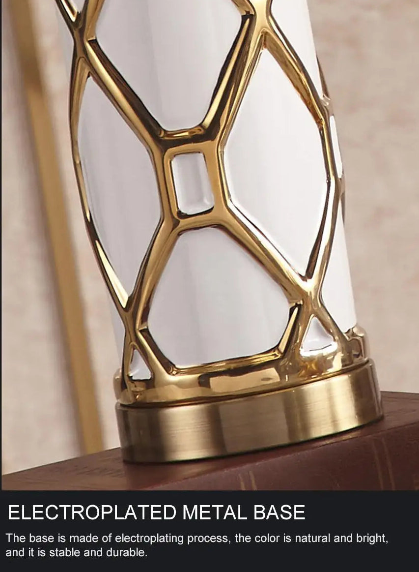 Decorative lamp with gold electroplated metal base on a neutral background
