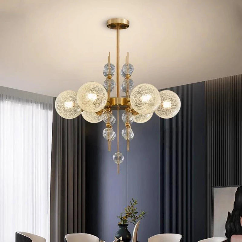 Modern chandelier with glass globe lights in a room setting.