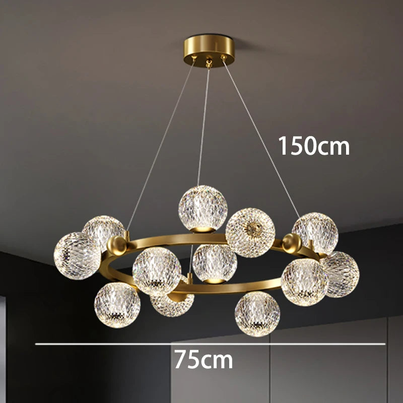 Chandelier with crystal balls and gold frame on a dark ceiling, measurements indicated.