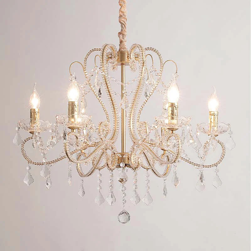 Gold candelabra chandelier with clear crystal accents and warm lighting.