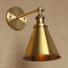 A collection of four different styles of gold industrial wall sconces displayed together.