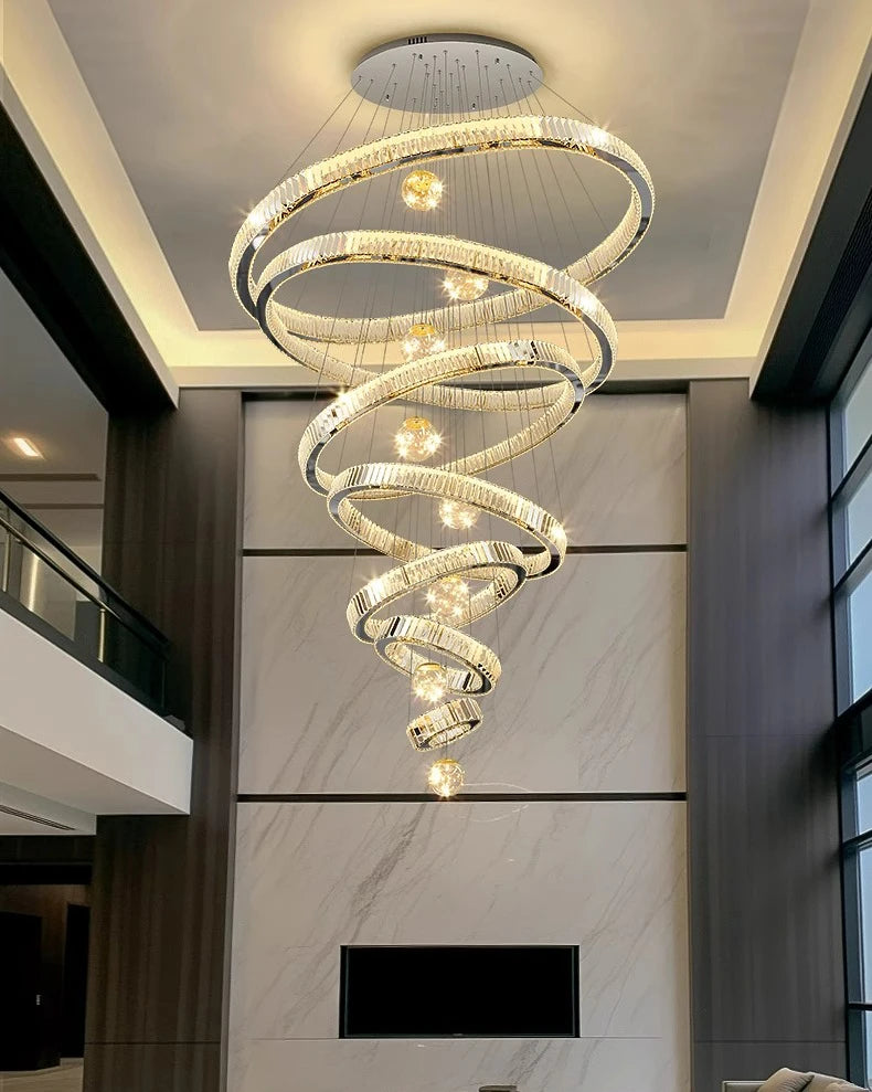 Modern spiral chandelier hanging from a ceiling in a stylish interior setting.