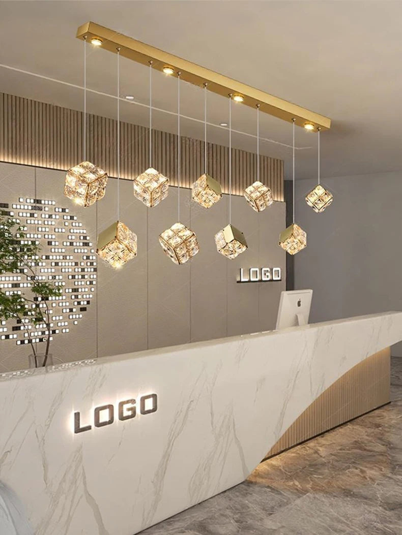 Modern interior design with a reception desk and decorative ceiling lights.
