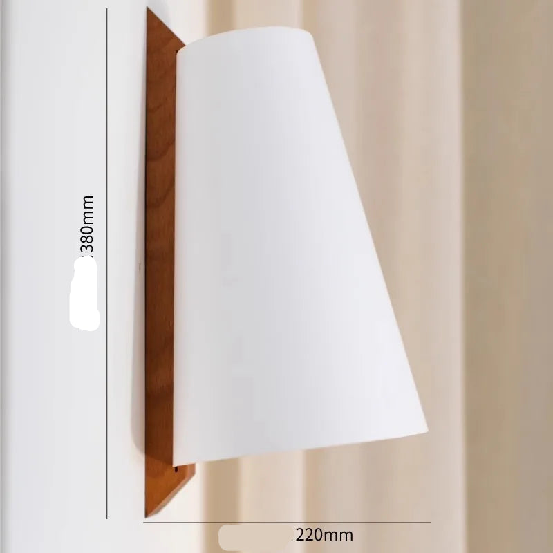 Wall-mounted light fixture with white shade and wooden frame on a neutral background