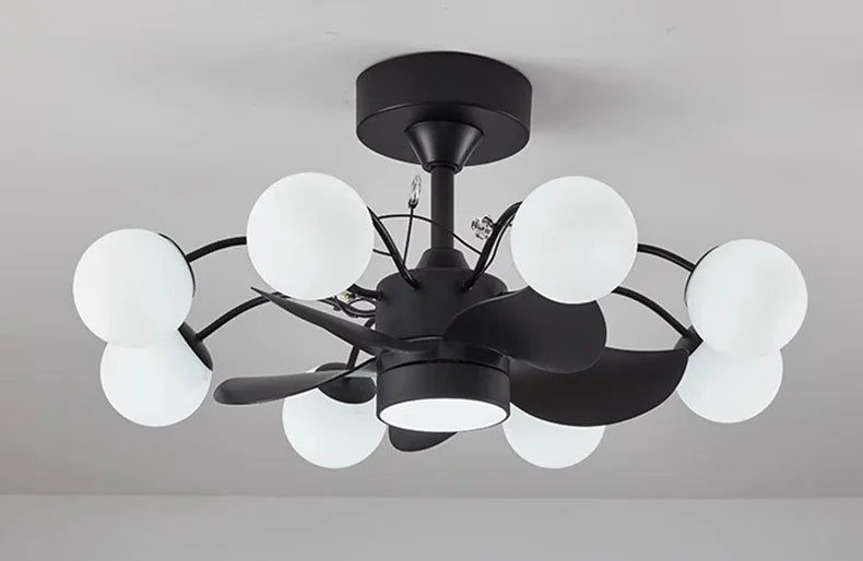 Modern black chandelier with white glass shades on a gray background