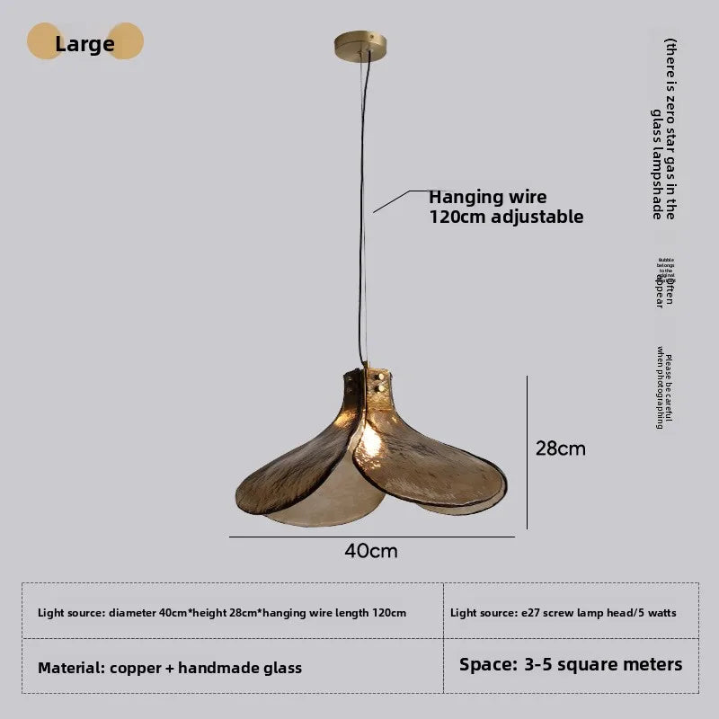 Gold pendant light with adjustable hanging wire on a gray background