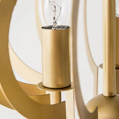 Detail shot of the bulb socket and internal structure of a gold geometric open frame pendant light.