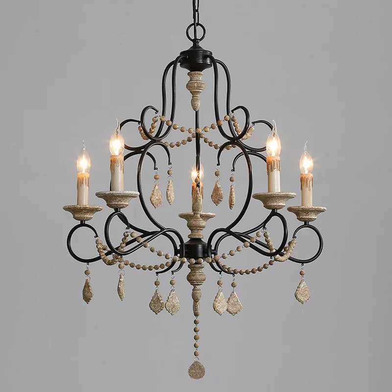 Black iron chandelier with wood beads and cascading crystal accents, featuring five candle-style lights.