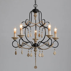 Black iron chandelier with wood beads and cascading crystal accents, featuring five candle-style lights.