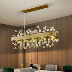 A close-up view of a rectangular gold chandelier with clear crystal accents.