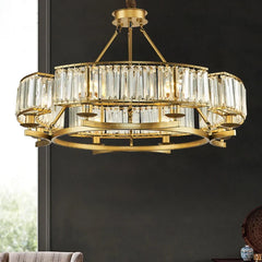Detail view of the gold crystal chandelier pendant light against a dark background.