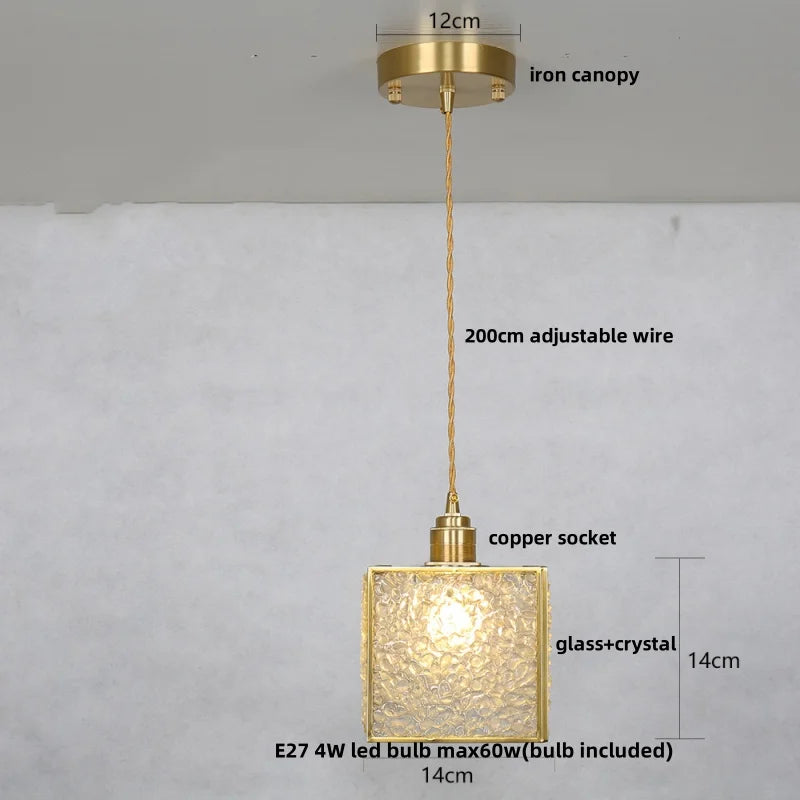 Gold pendant light with measurements on a gray background