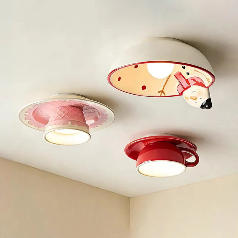 Three ceramic coffee cup ceiling lights mounted on a white ceiling, each emitting a warm glow.
