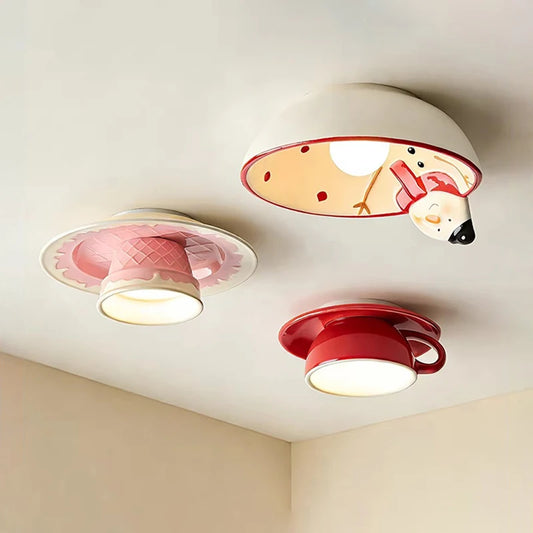 Three ceramic coffee cup ceiling lights mounted on a white ceiling, each emitting a warm glow.