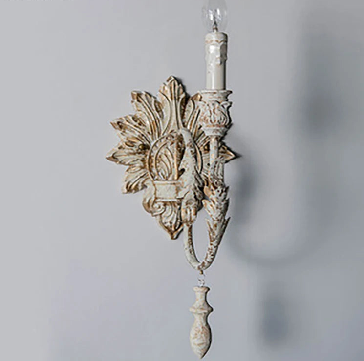 Decorative wall sconce with intricate design on a plain background
