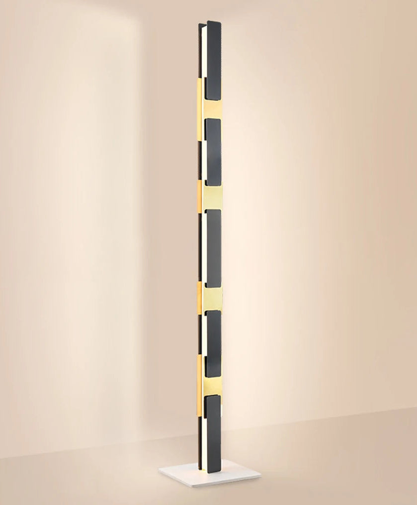 Modern floor lamp with black and gold design on a beige background