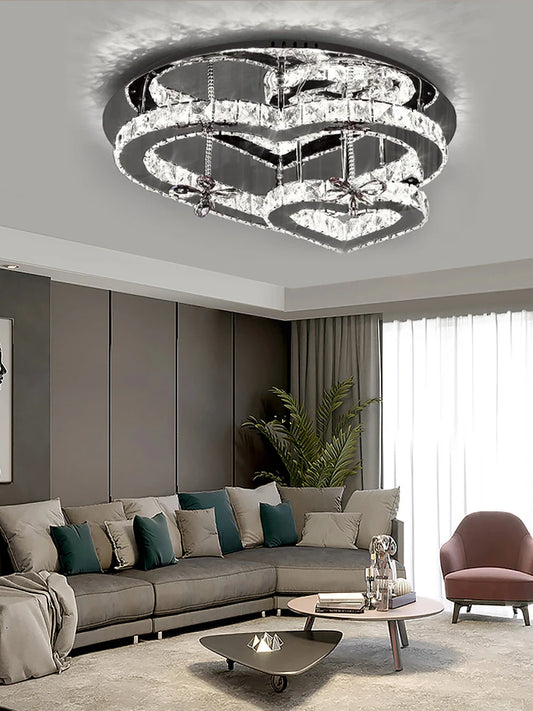 Close-up view of the crystal facets and heart-shaped tiers of a modern chandelier, showcasing its sparkling detail.