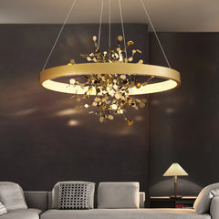 Close-up of the gold ring pendant light's intricate floral metalwork.