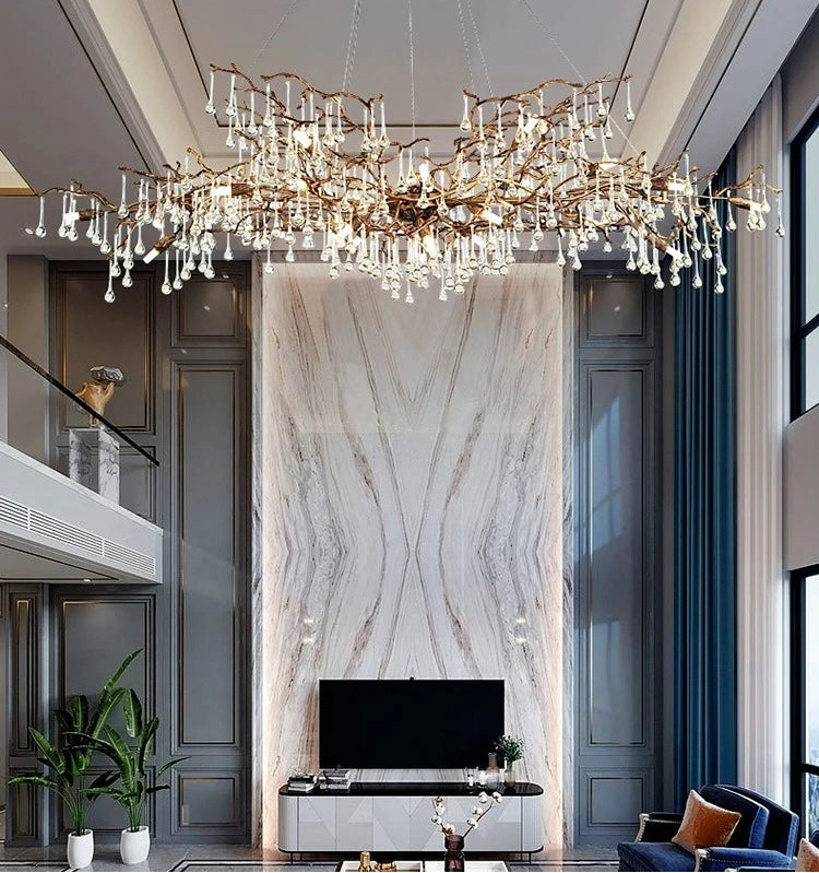 Luxurious living room with a large chandelier, marble wall, and modern furniture.
