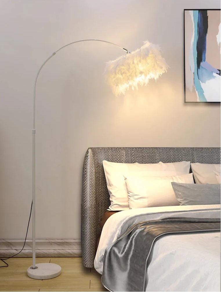 Floor lamp next to a bed in a bedroom setting