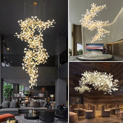 Gold ginkgo leaf chandelier with cascading branches, illuminated, in a modern living room.